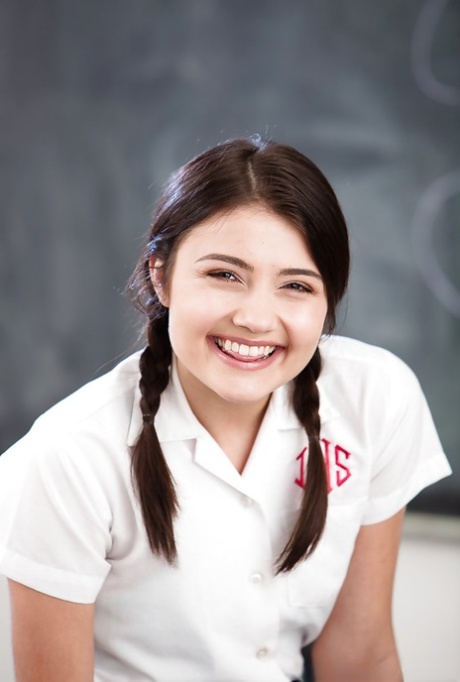 Молодая соло-девушка Адриа Рей обнажает крошечные сиськи и школьную попку с косичками 1